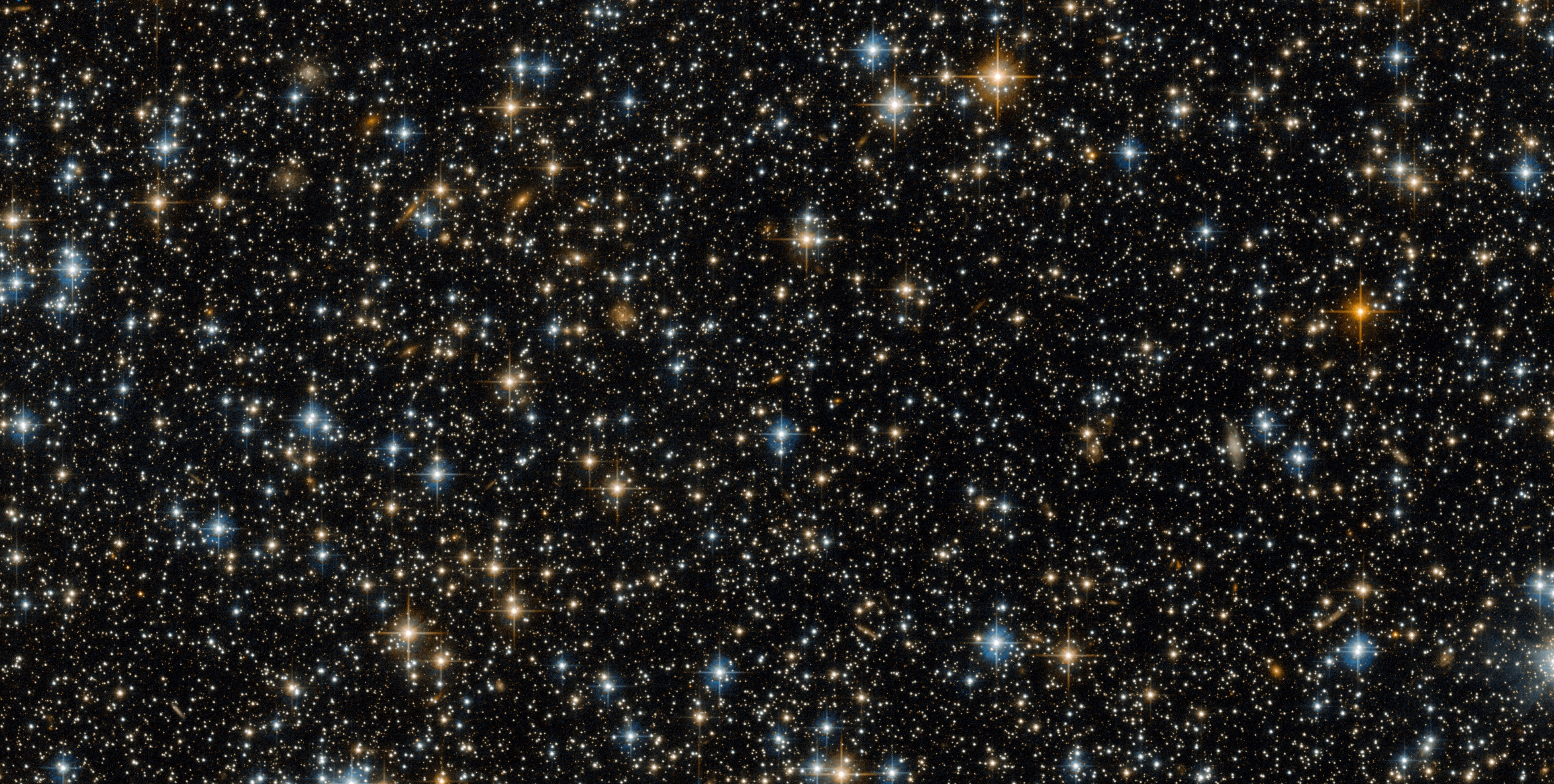 星々と遠い銀河が輝く宇宙の写真。ESA/Hubble & NASA